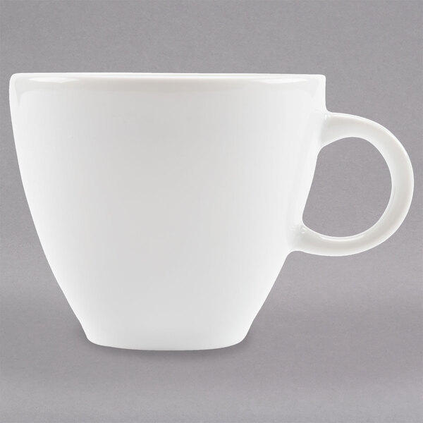 An Arcoroc white espresso cup with a handle.