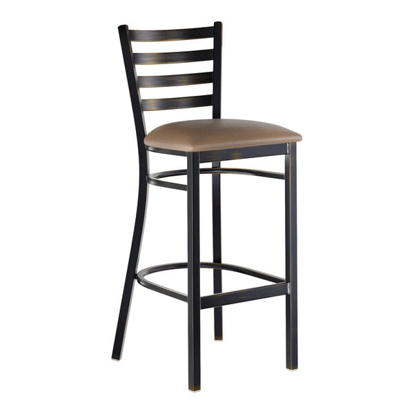 A metal ladder back bar stool with a distressed copper finish and a taupe vinyl padded seat.