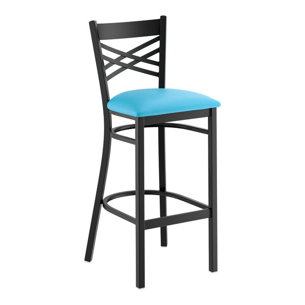 A black metal bar stool with a cross back design and a blue vinyl padded seat.