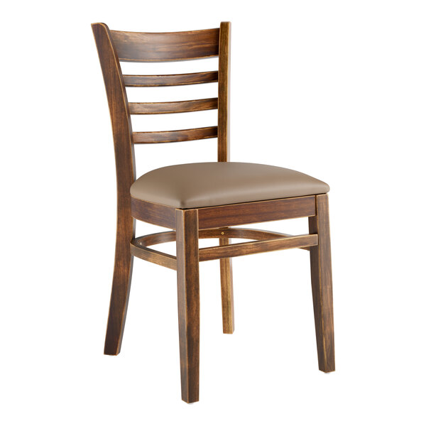 A Lancaster Table & Seating wooden ladder back chair with a taupe vinyl seat.