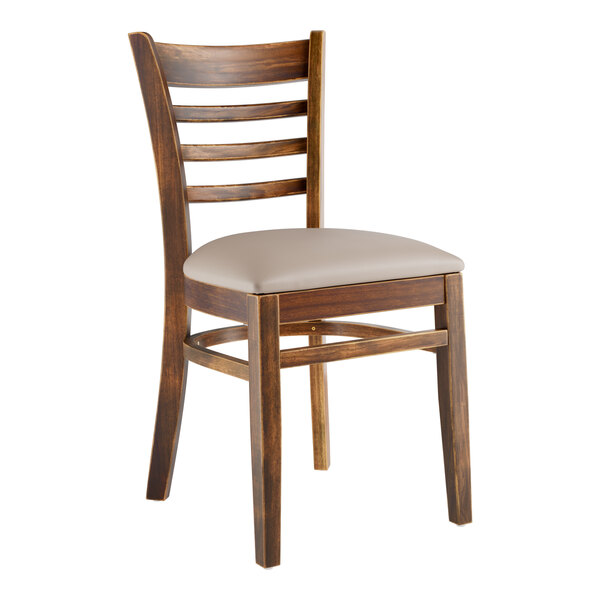 A Lancaster Table & Seating wooden ladder back chair with a light gray vinyl seat.