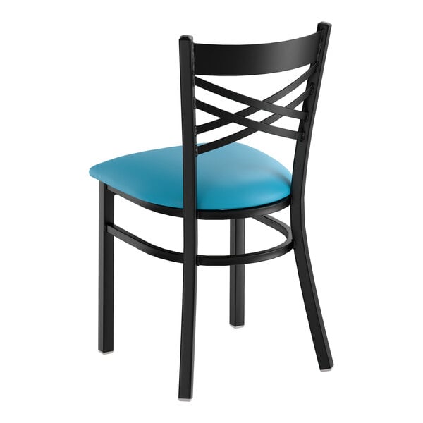 A black metal chair with a cross back design and a blue vinyl padded seat.