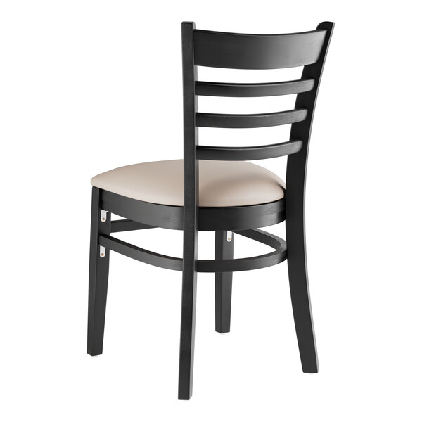 A Lancaster Table & Seating black wood chair with light gray vinyl seat and ladder back.