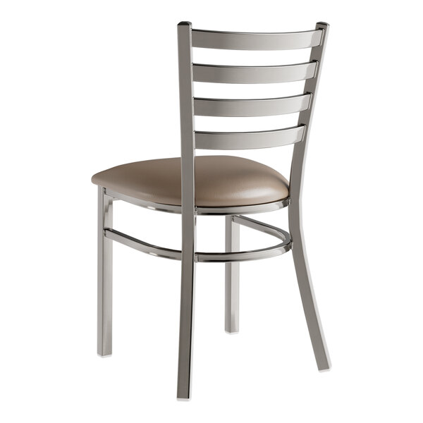 A Lancaster Table & Seating metal ladder back chair with taupe vinyl seat.