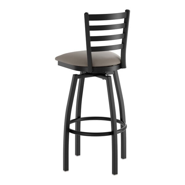 A black metal swivel bar stool with a ladder back and a dark gray vinyl padded seat.