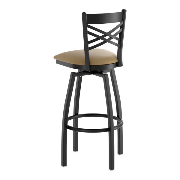 A black metal swivel bar stool with a cross back design and a taupe vinyl padded seat.