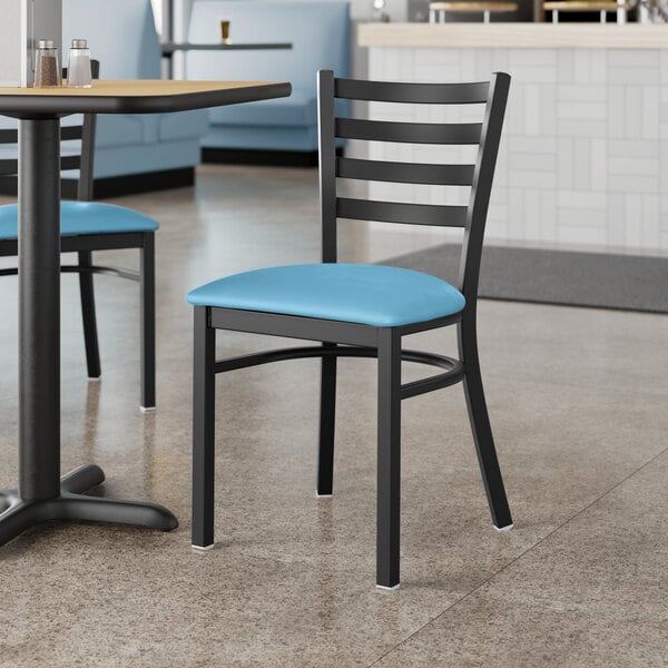 A Lancaster Table & Seating black metal restaurant chair with a blue vinyl padded seat.