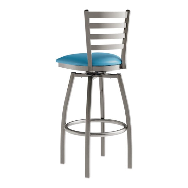 A Lancaster Table & Seating blue vinyl padded swivel bar stool with metal legs.