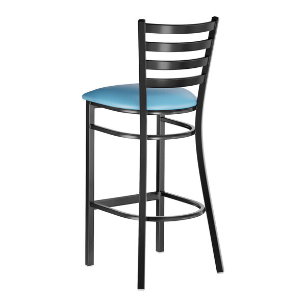 A black metal bar stool with a ladder back design and a blue vinyl padded seat.
