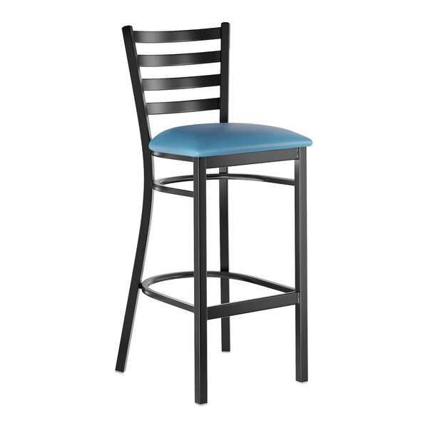 A black metal bar stool with a ladder back design and a blue vinyl padded seat.