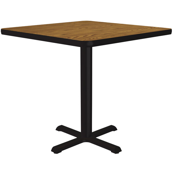 A Correll square table with a medium oak thermal-fused laminate top and a black base.