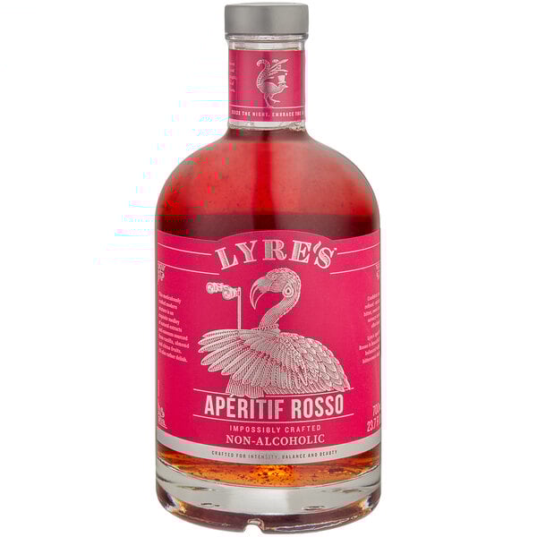 A Lyre's Aperitif Rosso non-alcoholic vermouth bottle with a pink label on a table.