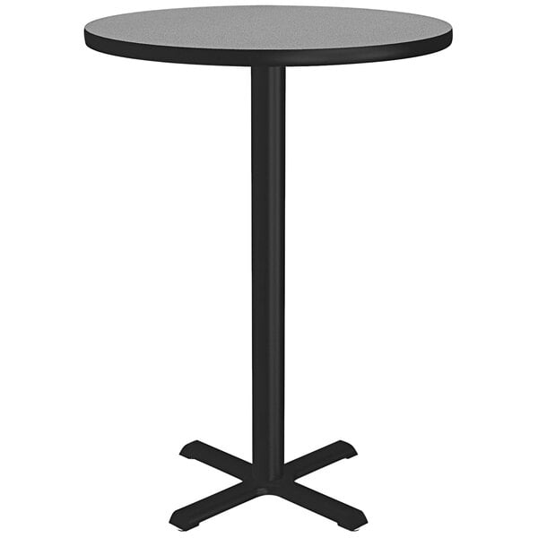 A Correll round bar height table with a gray granite finish top and black base.