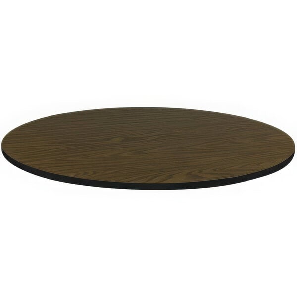 A Correll round walnut laminate table top with a black edge.