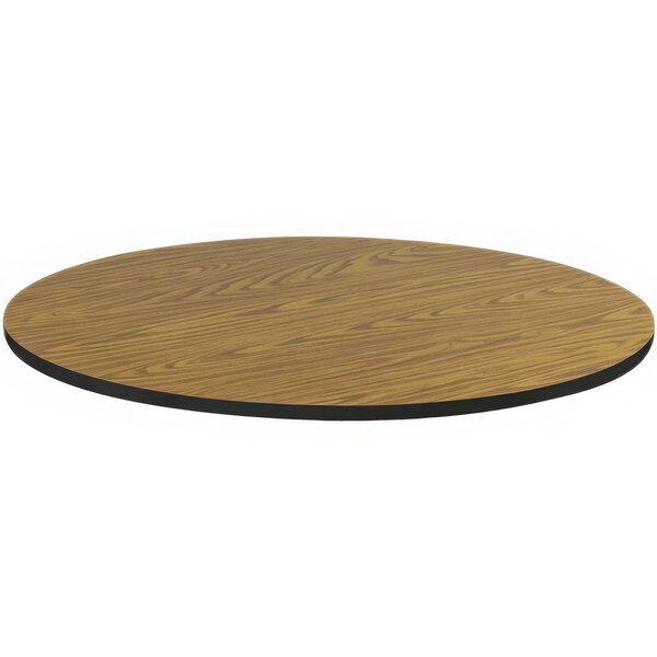 A Correll medium oak laminate round table top with a black edge.