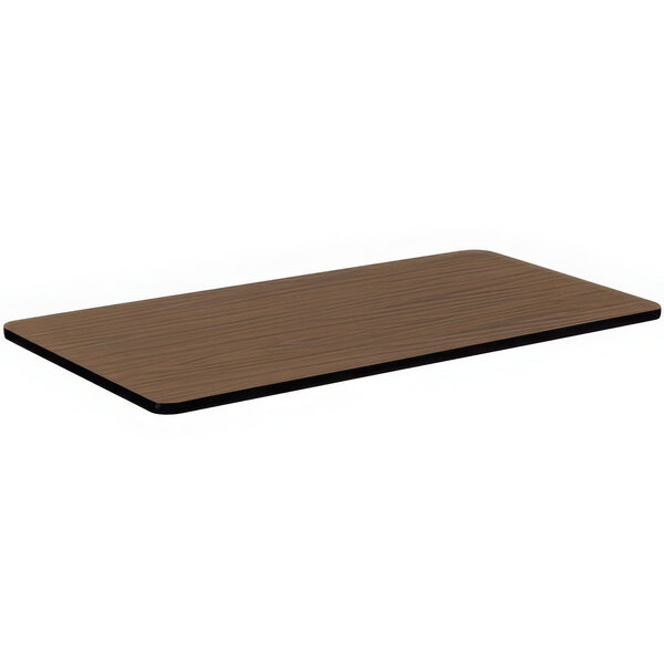 A rectangular brown wood table top with black edges.