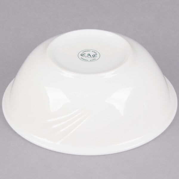 A white CAC Garden State porcelain bowl with a logo on it.