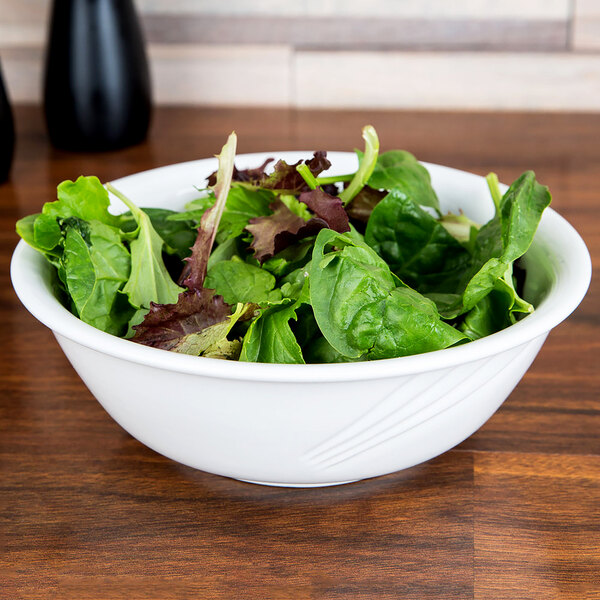 A CAC Garden State white porcelain bowl filled with green and red salad.