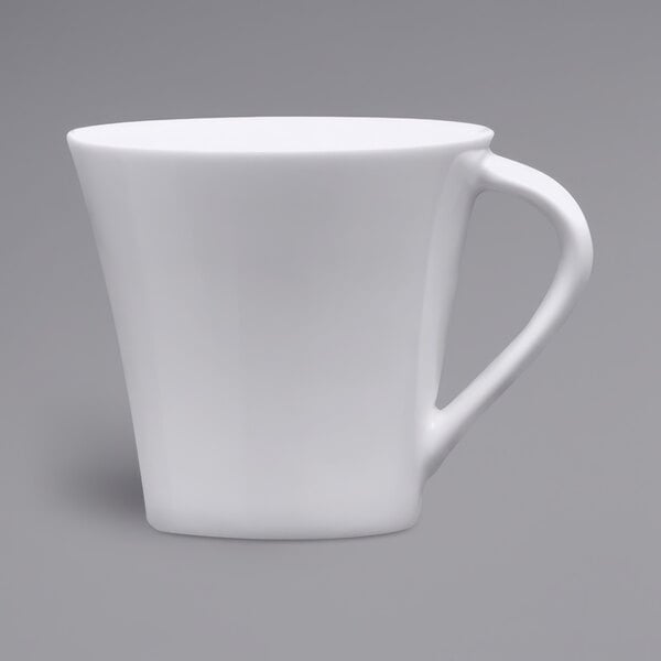 A close up of a Fortessa Tavola bright white porcelain espresso cup with a handle.