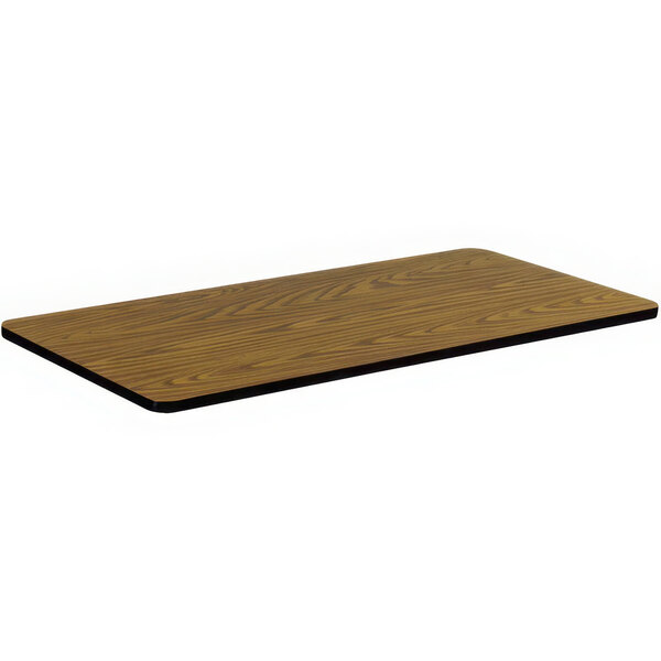 A Correll rectangular wood table top with a medium oak finish.