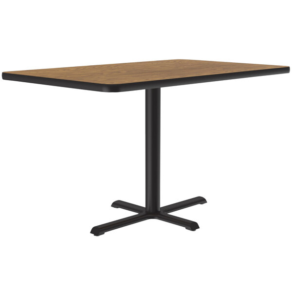 A Correll rectangular medium oak table with a black base.