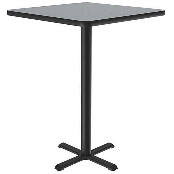 A Correll bar height table with a black metal base and a gray granite finish square top.
