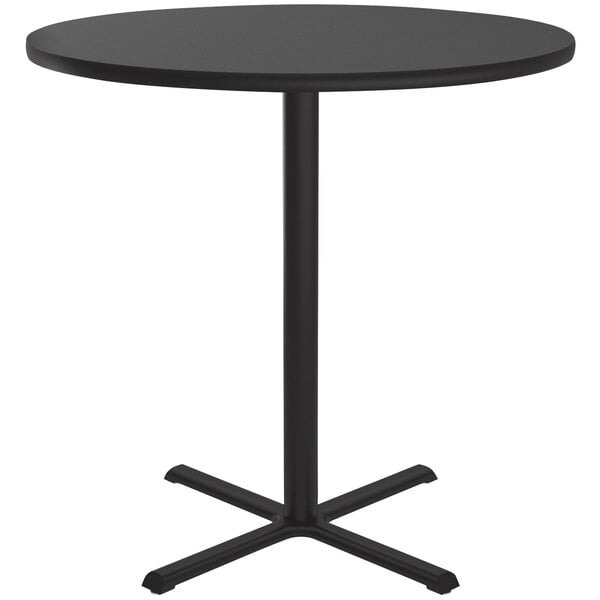 A Correll black granite finish round bar height table with a metal base.