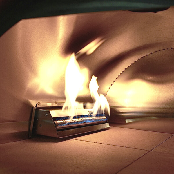 A close-up of a fire burning in a WPPO hybrid dual fueled outdoor pizza oven.