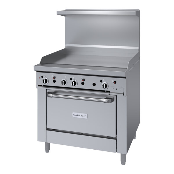 A large stainless steel Garland gas range with a griddle and two burners.