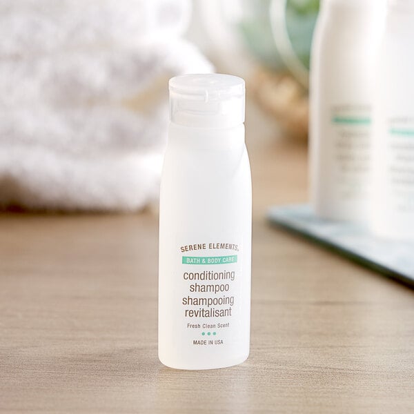 A close-up of a white Serene Elements shampoo bottle with a green label.