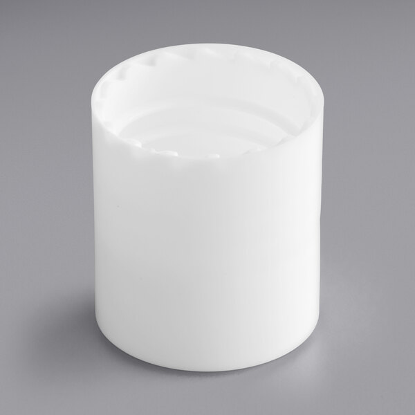 A white cylindrical object with a hole.