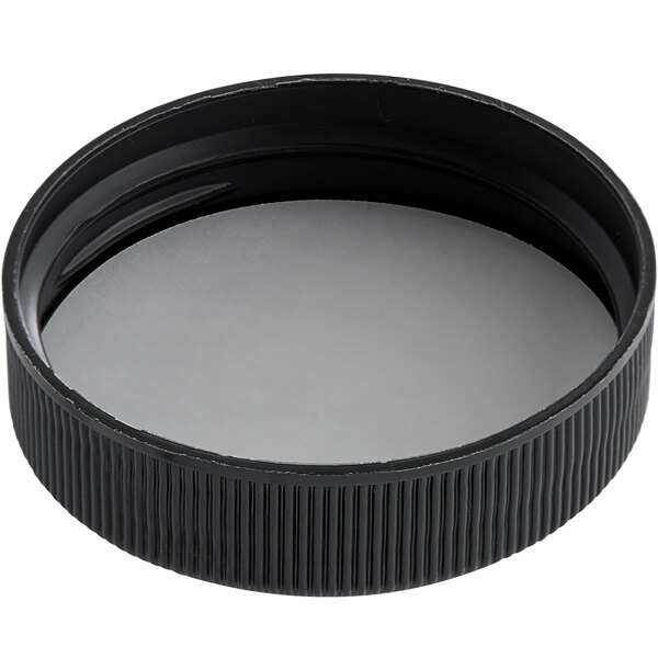 A black plastic cap with a white circle.