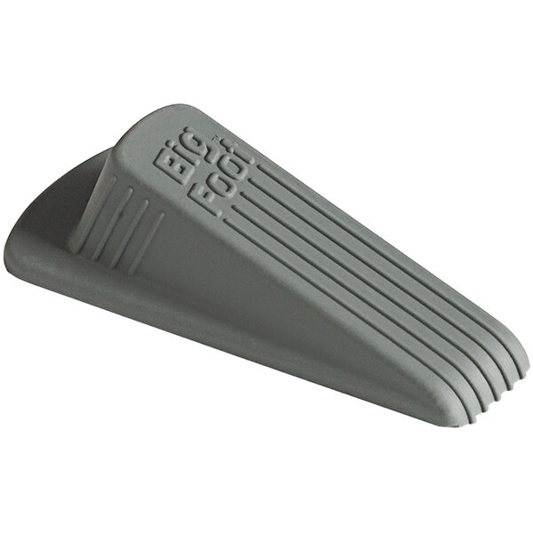 A grey rubber Master Caster Big Foot door stop with text on it.