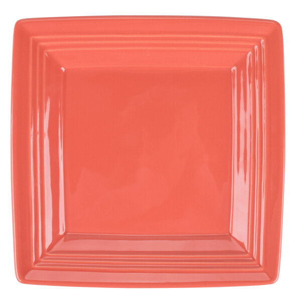 A Tuxton Concentrix square china plate in coral with a square design.