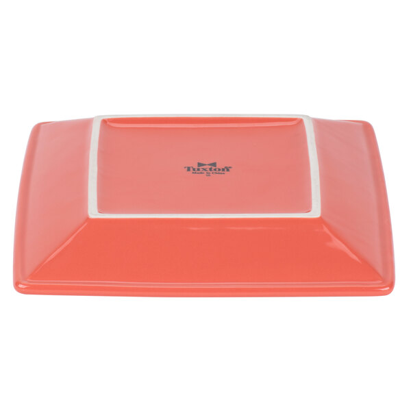 A square orange Tuxton Concentrix china plate with a white border.