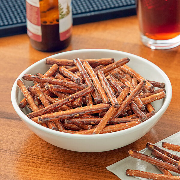 A bowl of Tom Sturgis Thick Stiks pretzels on a table.