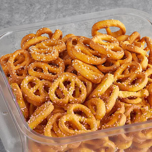 A container of Tom Sturgis Little Cheesers pretzels on a table.