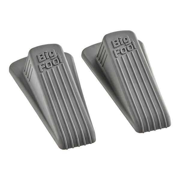 A pair of Master Caster grey rubber door stop wedges with a close-up of a grey rubber foot pedal.