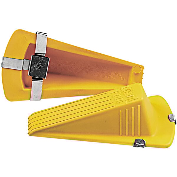 A close-up of a yellow plastic Master Caster door stop with metal clips.