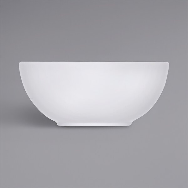 A Bauscher bright white porcelain bowl on a gray surface.