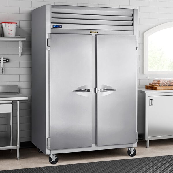 A Traulsen G Series reach-in freezer with two doors in a stainless steel kitchen.