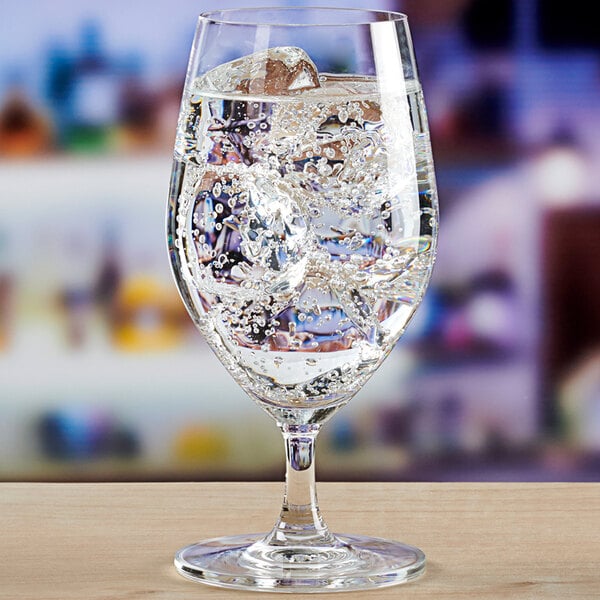An Anchor Hocking Sondria wine goblet filled with ice water on a table.