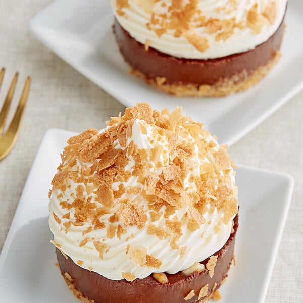 A dessert topped with Cacao Barry Feuilletine Biscuits on a plate.
