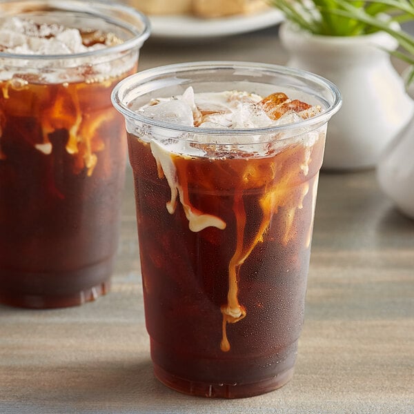 A couple of plastic cups of Toddy Colombian Cold Brew Coarse Ground Coffee over ice.