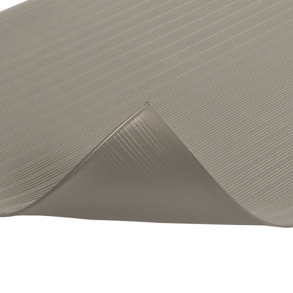 A close-up of the folded edge of a gray Notrax Airug anti-fatigue mat.