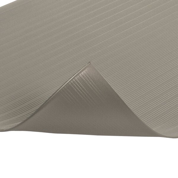 A close up of a gray Notrax Airug anti-fatigue mat with a folded edge.