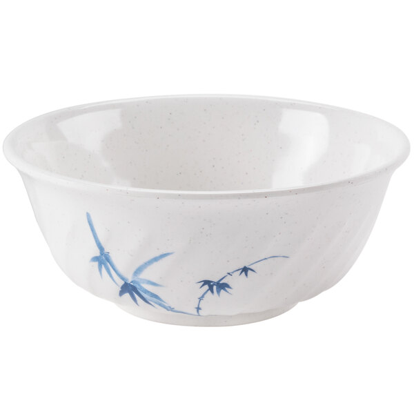 A white melamine bowl with blue bamboo designs.