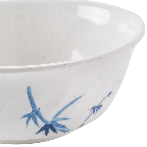 A close up of a Thunder Group Blue Bamboo melamine swirl bowl with a blue and white bamboo design.