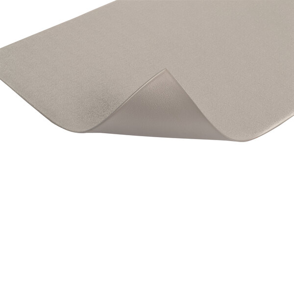 A folded edge Notrax gray anti-fatigue mat on a table.