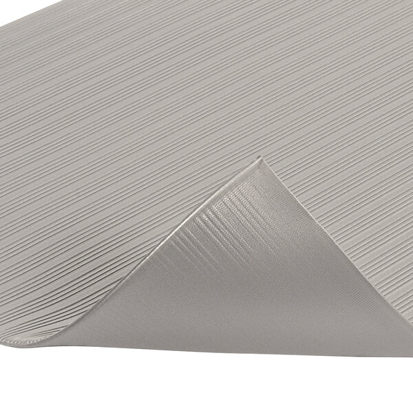 A close up of a gray Notrax Comfort Rest Ribbed Anti-Fatigue Mat.